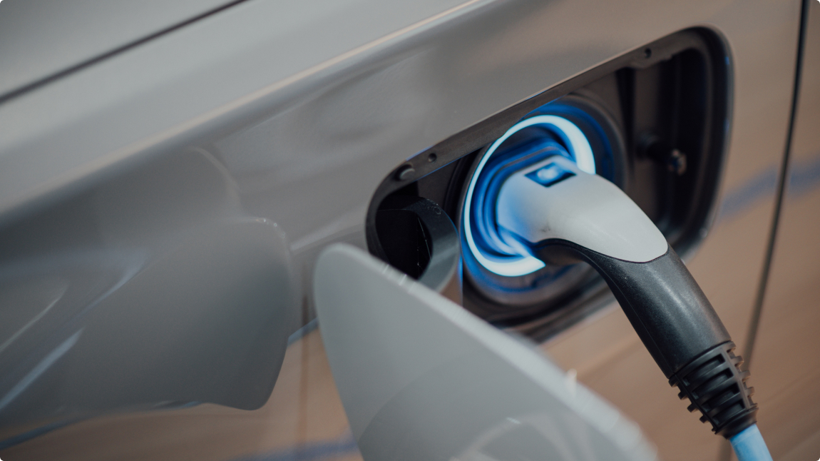 Close up of a charger plugged into a grey car