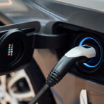 Electric vehicle with charging cable plugged in