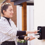 Person smiling using the Ohme ePod charger