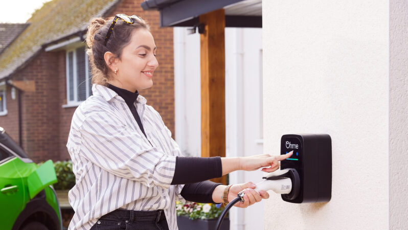 Person smiling using the Ohme ePod charger