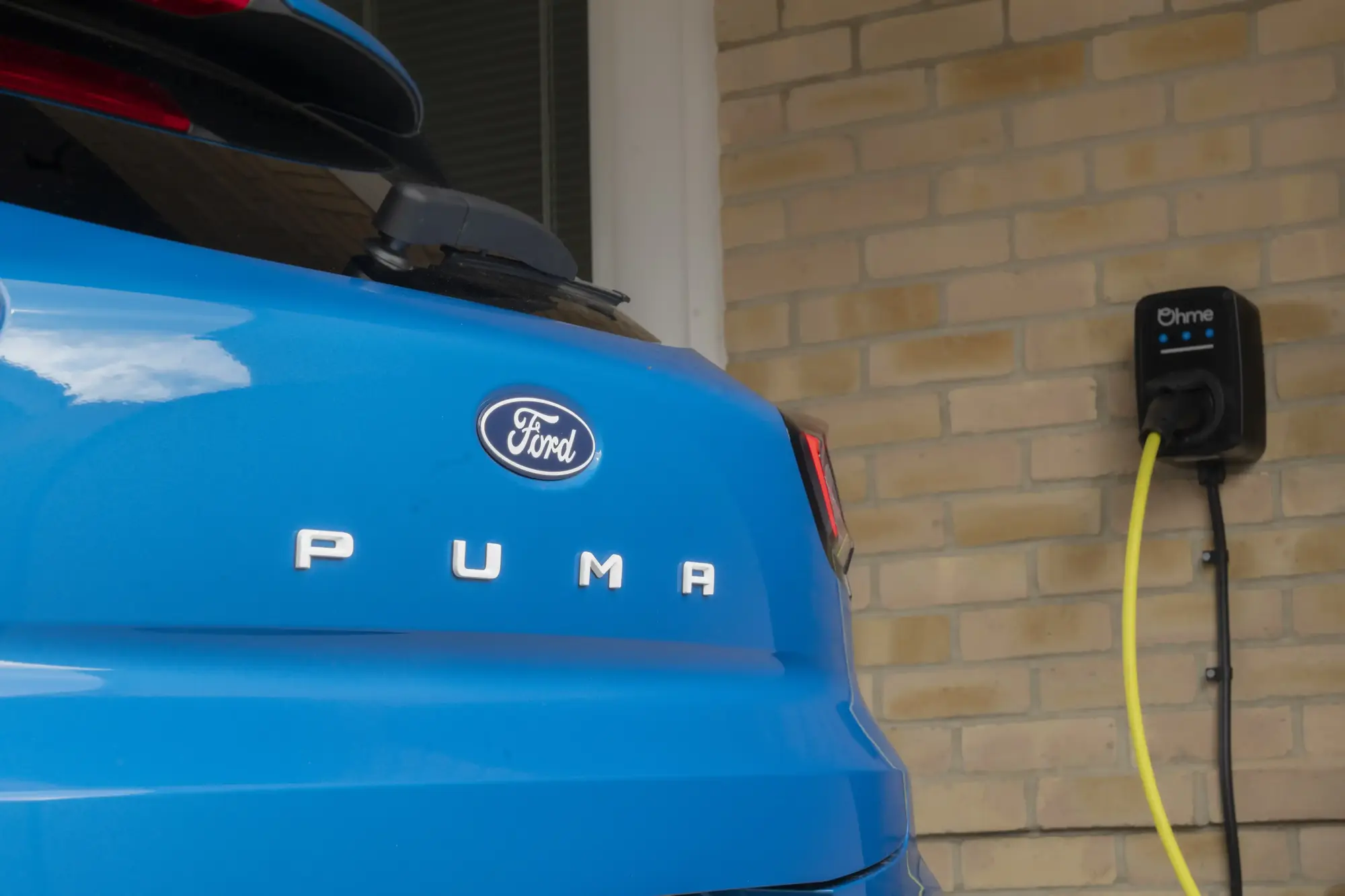 Blue Ford Puma plugged in to Ohme epodes home EV charger