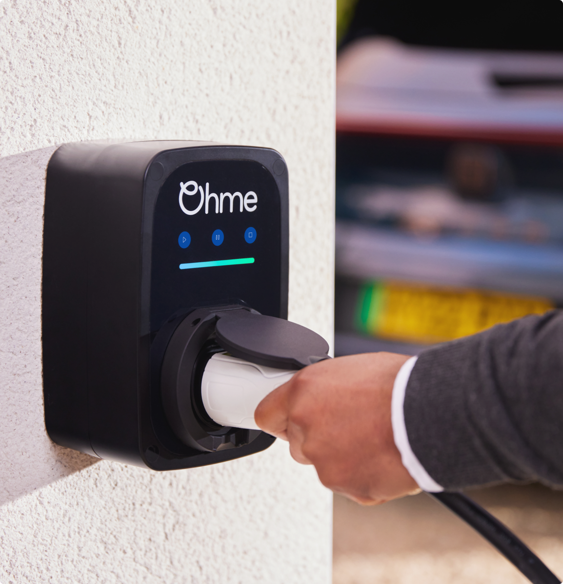 ePod on a wall with male hand holding charge cable
