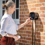 Lady using Ohme Home Pro Ev Charger