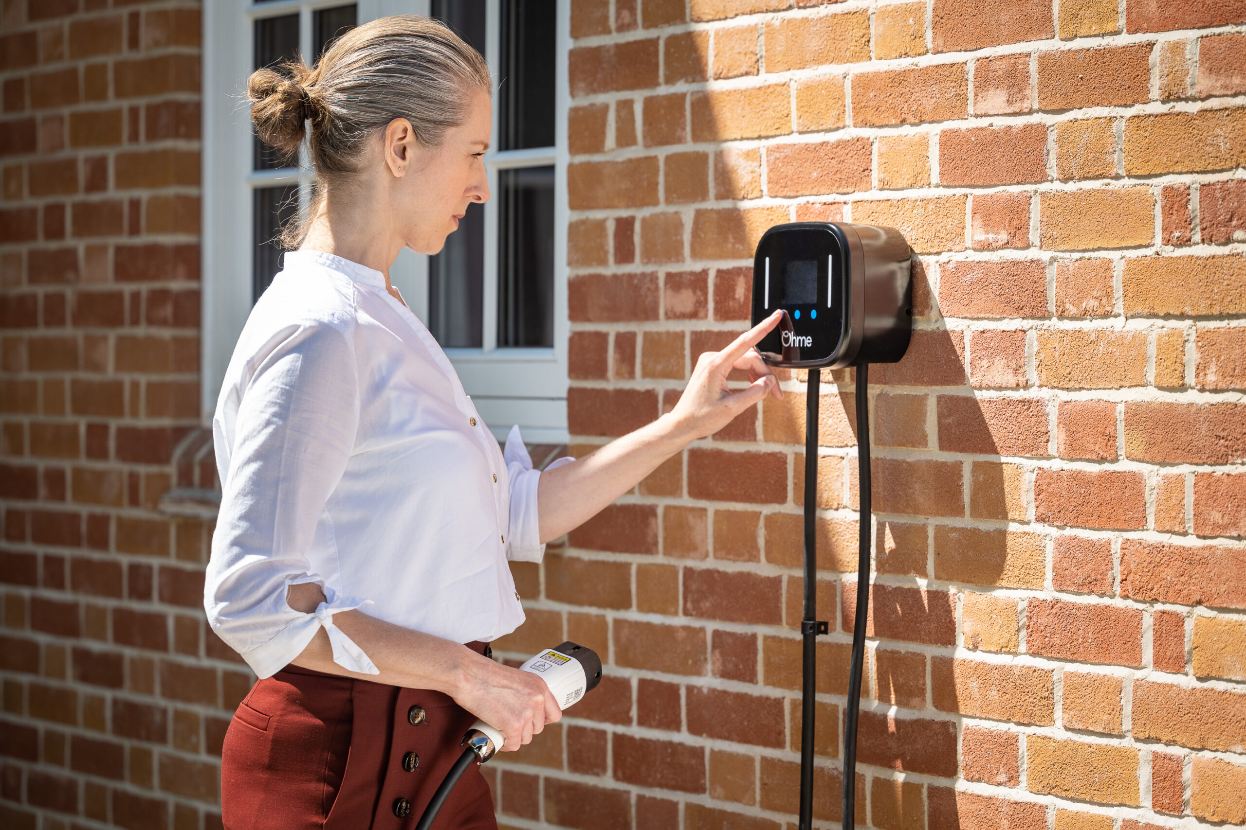 Lady using Ohme Home Pro Ev Charger