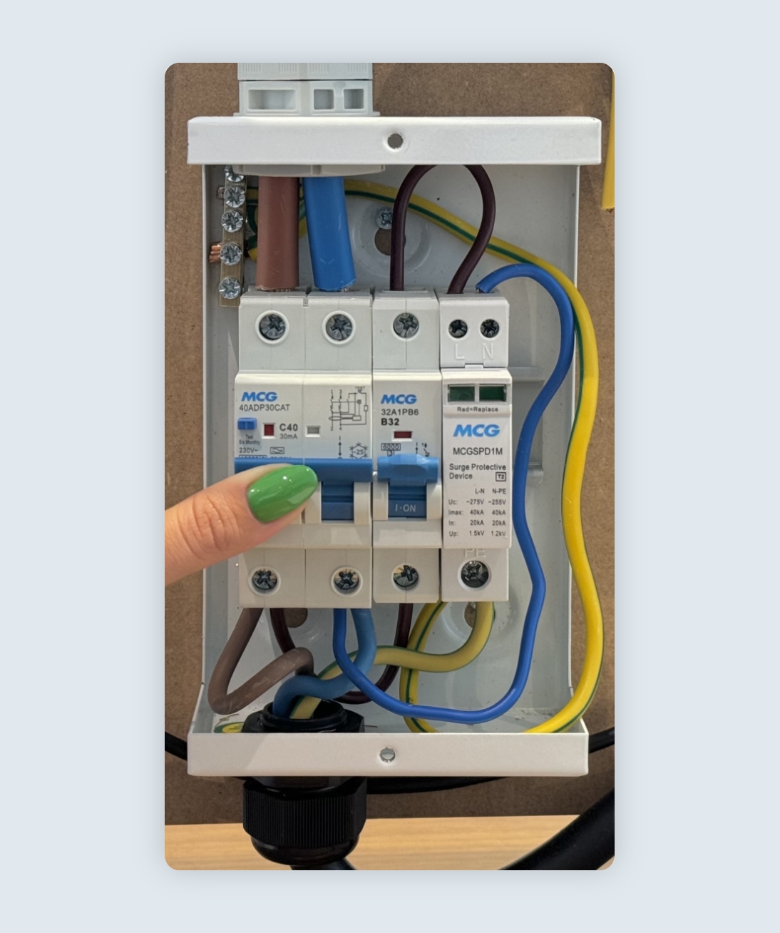 person pushing switch up to power RCBO on
