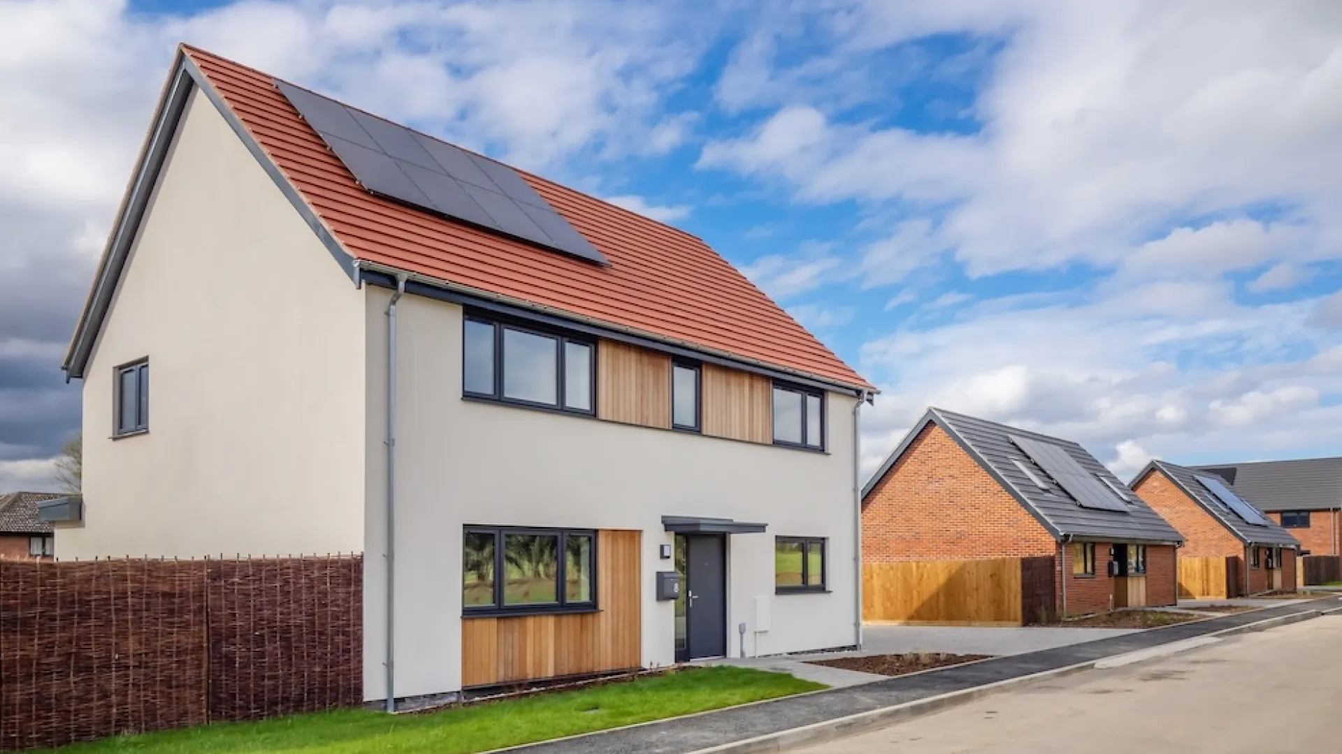 New build Abel Homes house- White House with red rood and solar panels on a new estate.